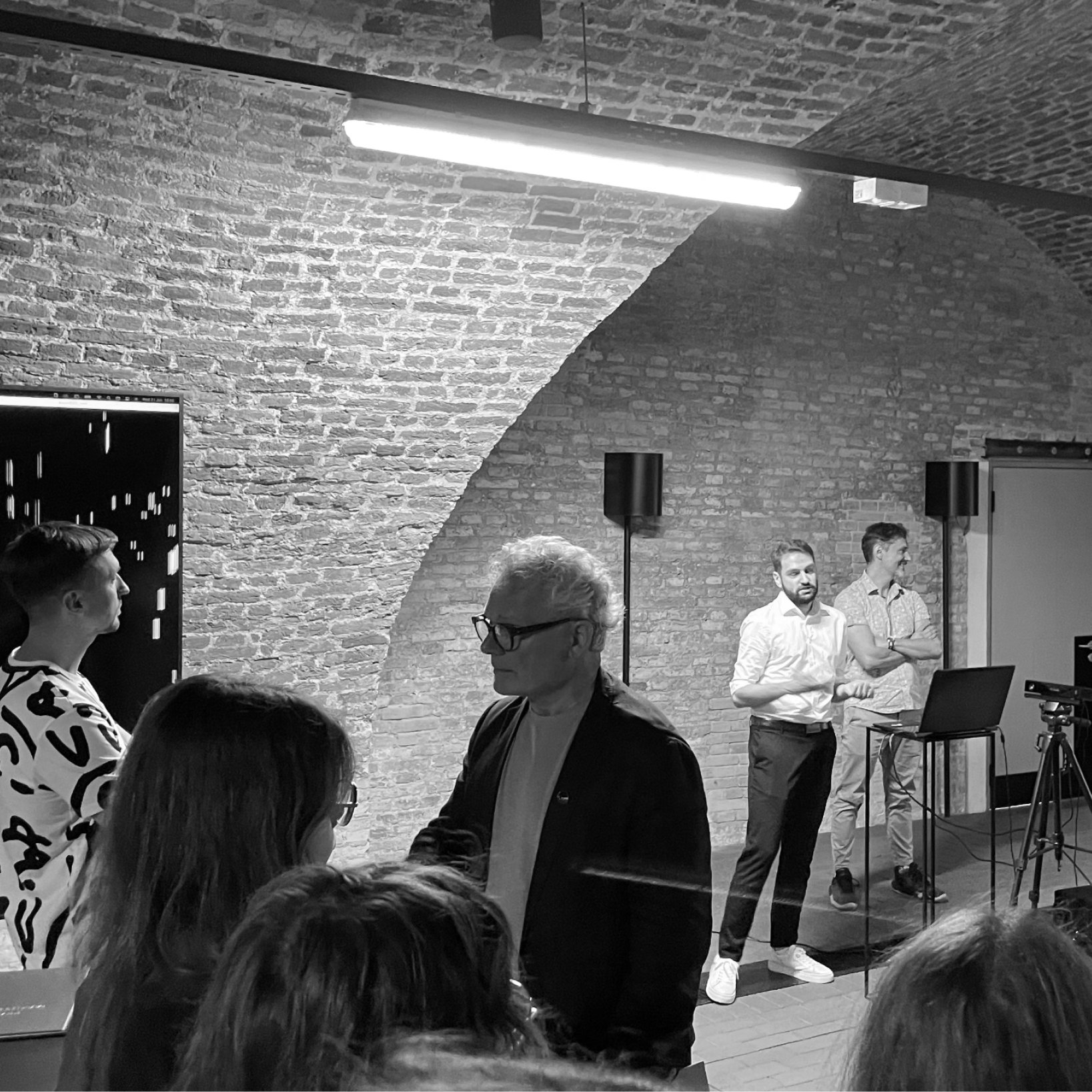 Visitors gathered around an installation in the vaulted Great Armory space.