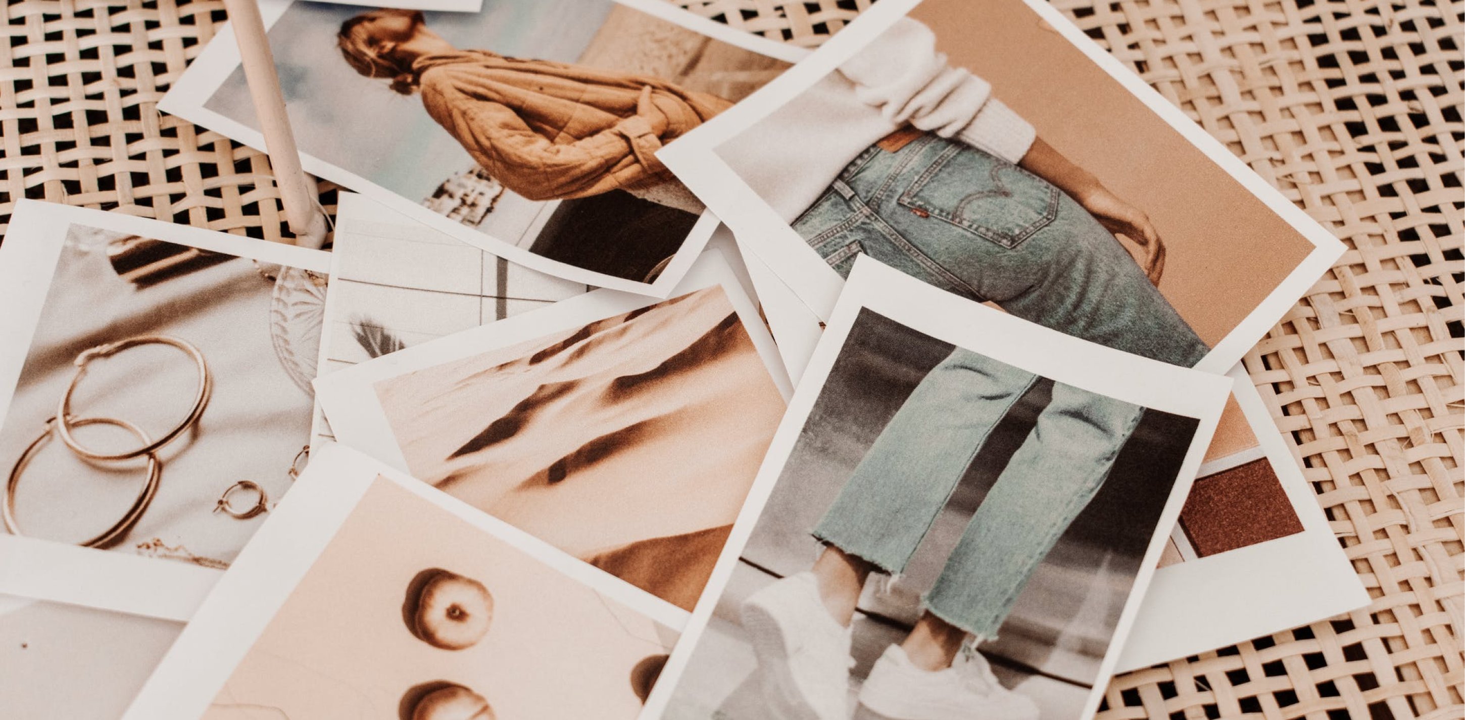 Stack of printed photos scattered on a table.