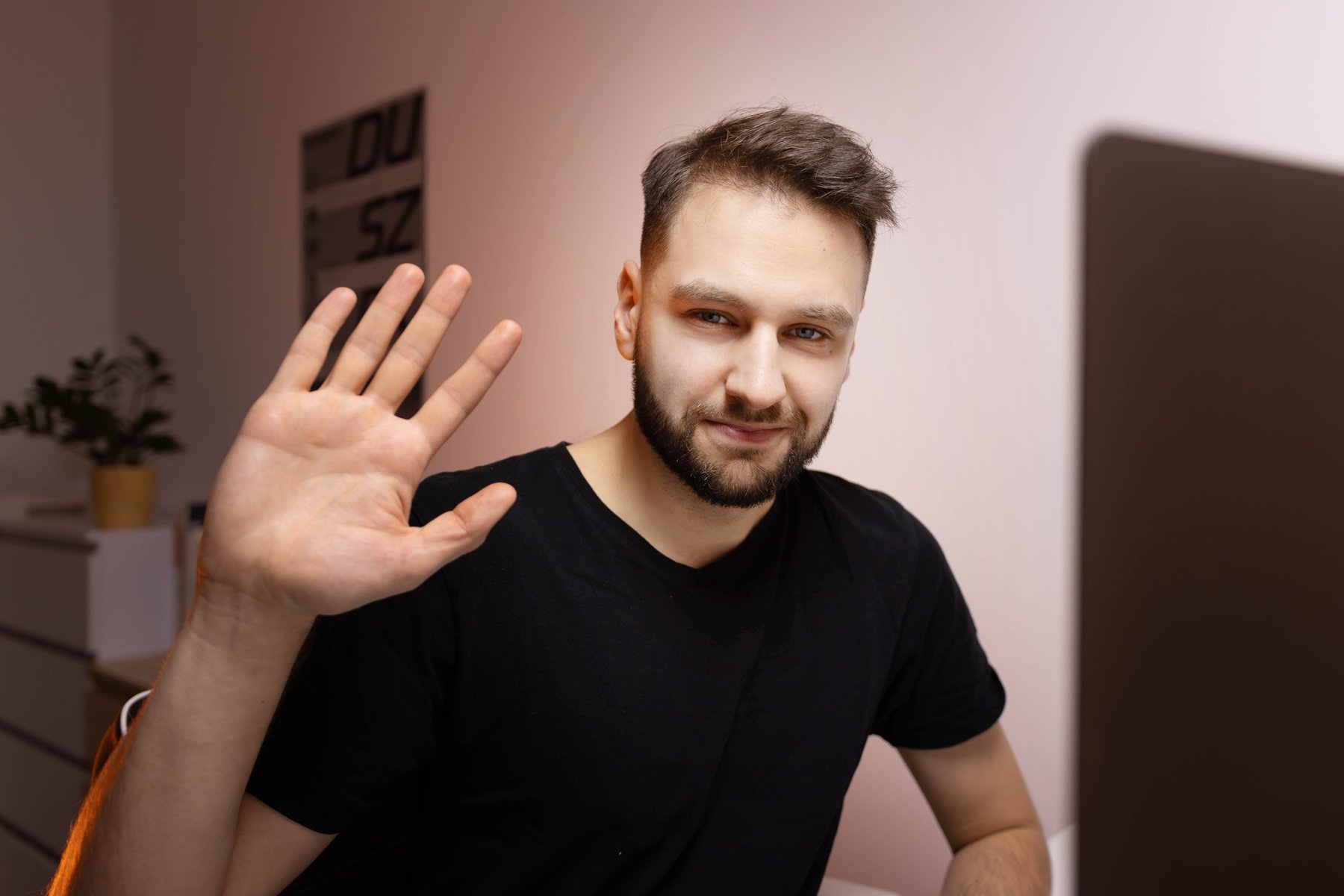 Jakub Żywuszko waving at the camera
