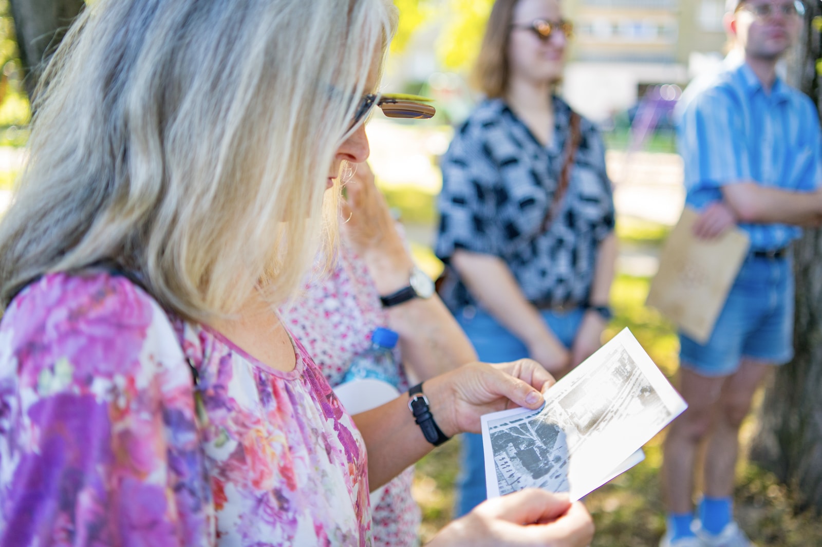 Workshop participant reviewing printed material during an outdoor session.